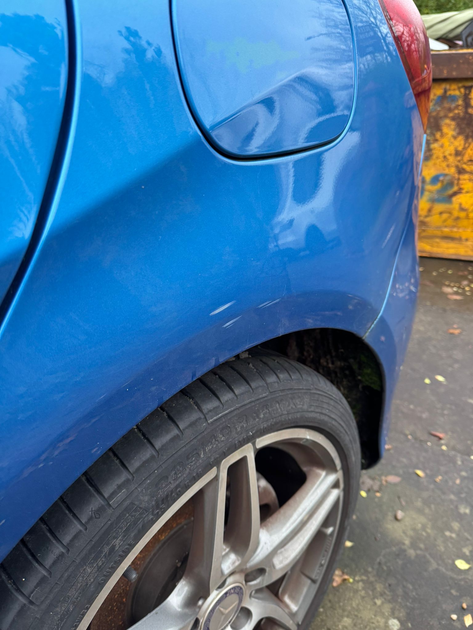 Blue vehicle rear quarter repair