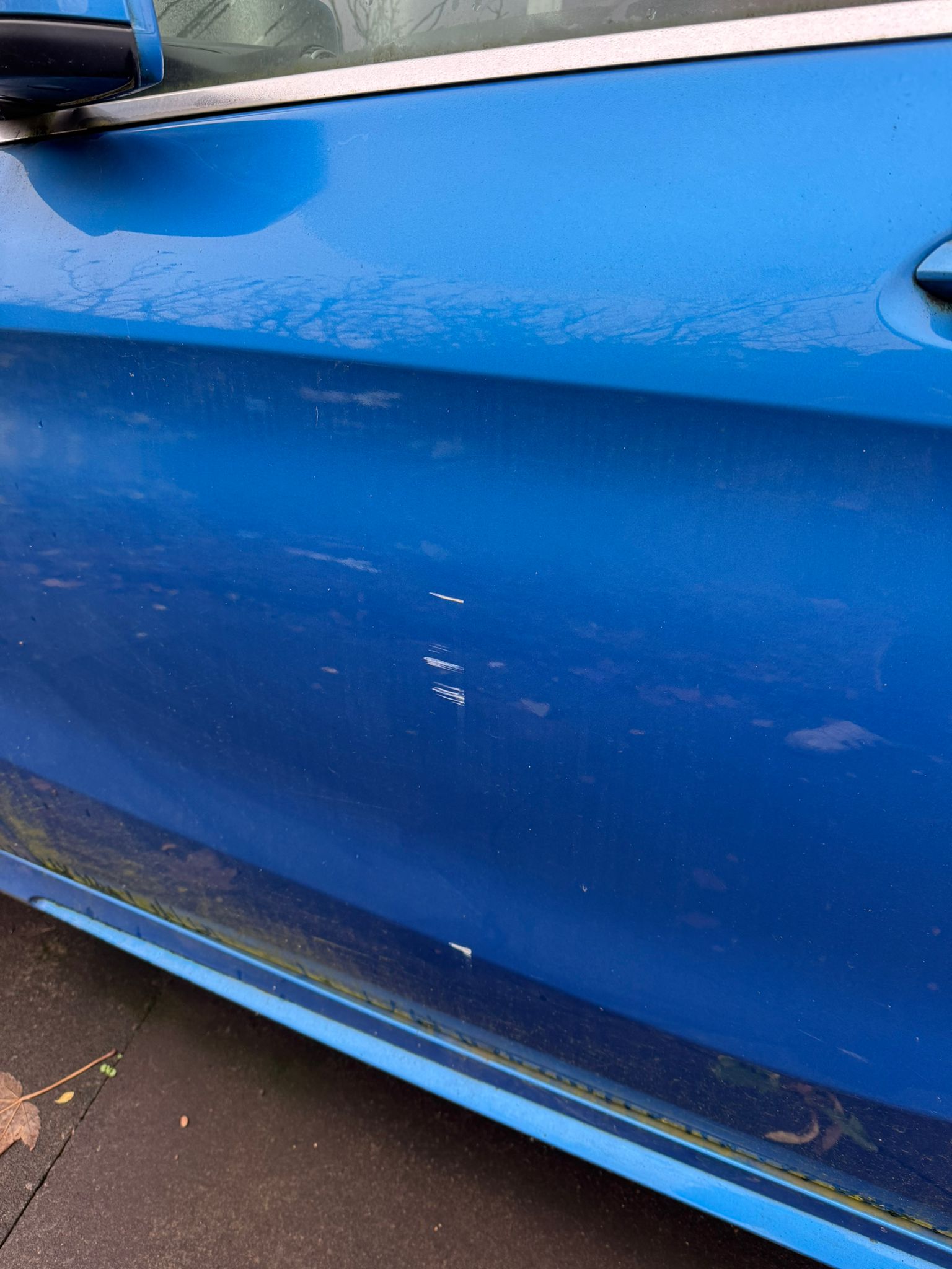 Blue vehicle side scratch repair
